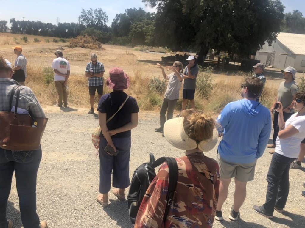 Group listens to women presenting near field.