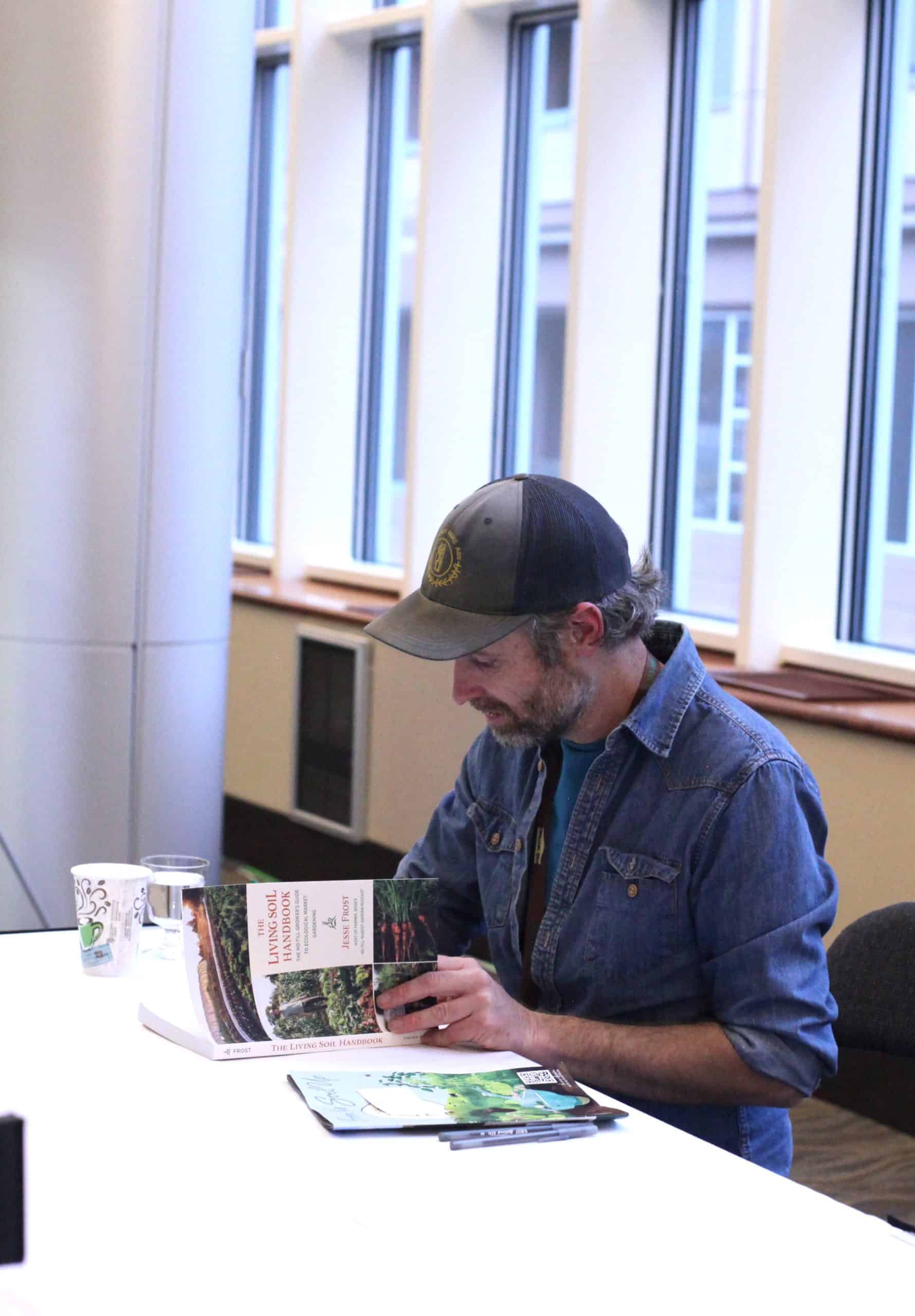 Jesse Frost signing his book.