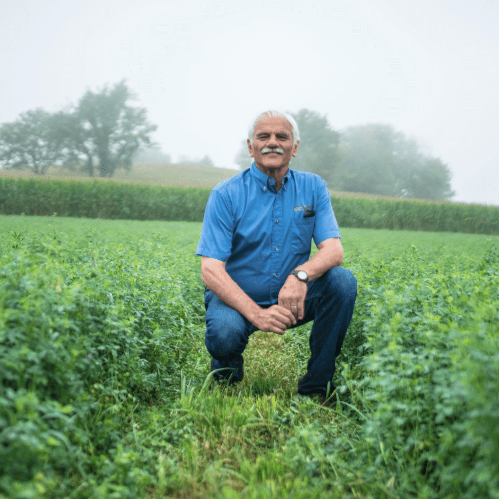 Gary Zimmer kneeling in field