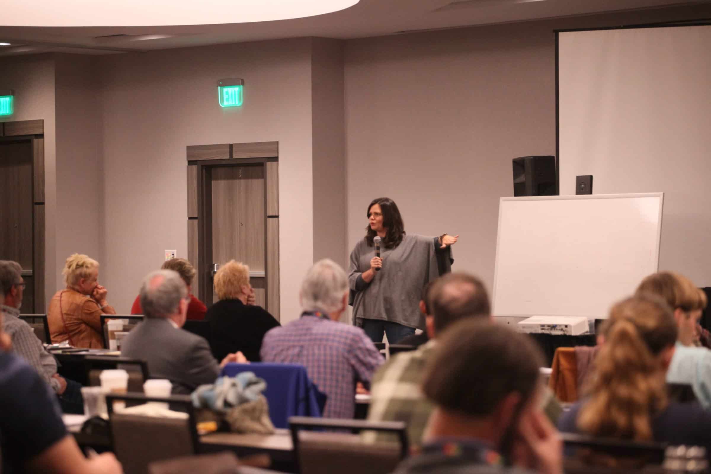 Nicole Masters points to a whiteboard for an Eco-Ag U workshop presentation